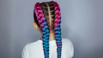Back view of long colorful pink and blue braids from professional hair braiding Bali